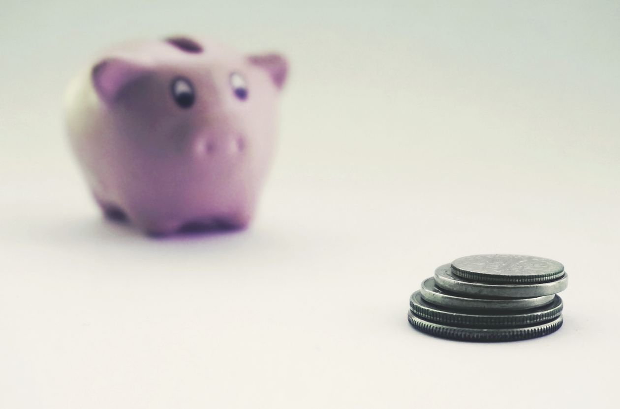 Piggy bank and stacked coins representing an emergency savings fund