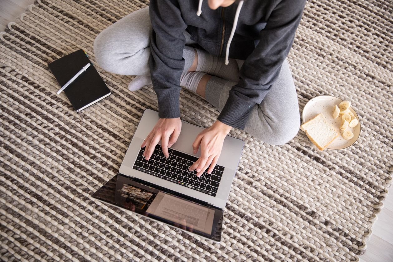 Woman typing on a laptop at home to set up a new online banking password
